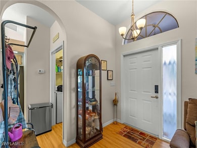 Foyer entrance with light wood-type flooring, wash