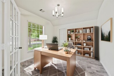 A private study through double glass doors adds a