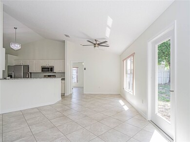 Unfurnished living room featuring a ceiling fan, light tile patterned flooring, and high vaulted ceiling
