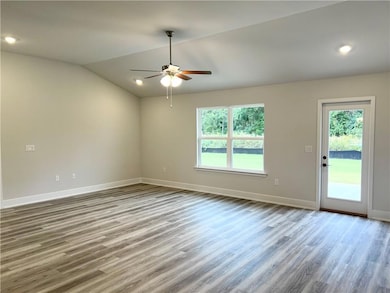 Unfurnished room featuring light wood-style floors, lofted ceiling, recessed lighting, and a ceiling fan