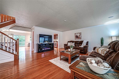 Spacious living room adorned with rich hardwood fl