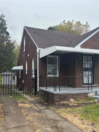 View of side of home with brick siding, a porch, roof with shingles, and a chimney