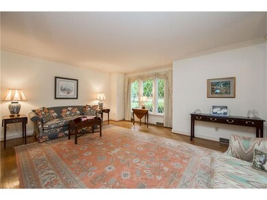 Living Room with triple front window and hardwood 