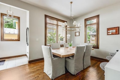 Dining space featuring a chandelier, dark wood fi