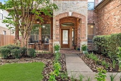 Brick and stone front elevation, front porch, and