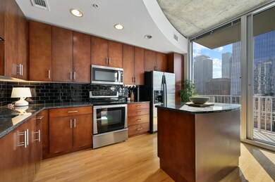 Kitchen featuring stainless steel appliances, lig