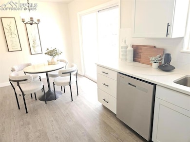 Dining area with light wood finished floors, a cha