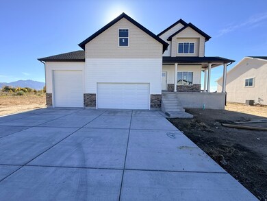 View of front of house featuring stone siding, covered porch, driveway, and a mountain view