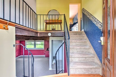 Stairs with baseboards and a towering ceiling