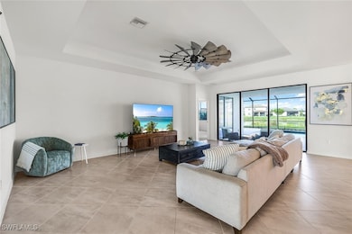 Tiled living room with a raised ceiling and ceilin