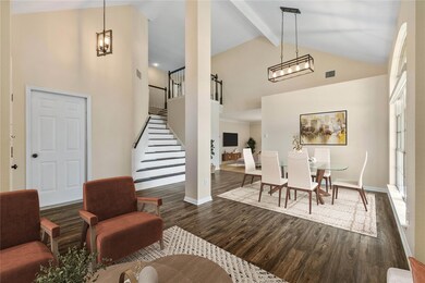 Dining room featuring high vaulted ceiling, stair