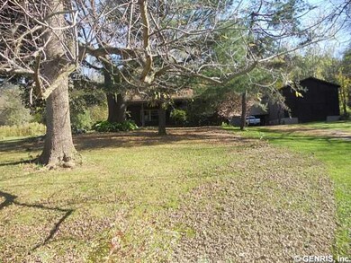Exterior Front Trees provide privacy, although the