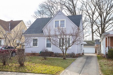 View of front facade featuring a front lawn and a garage