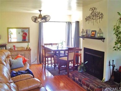 The living room has a charming fireplace and is fl