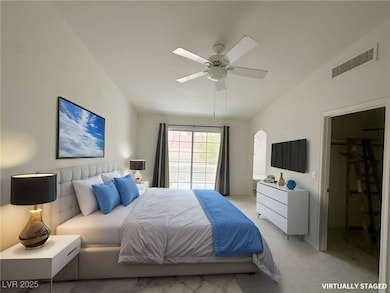 Bedroom featuring visible vents, ceiling fan, arch