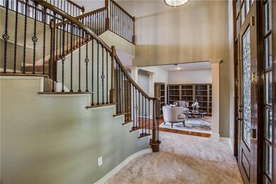 Beautiful foyer leading into home with staircase t