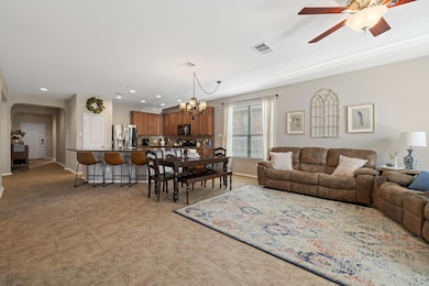 Living area with a chandelier, arched walkways, c