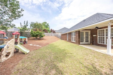 View of yard featuring french doors, a playground, and a patio area