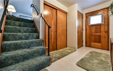 Foyer view from the game room with stairs leading 