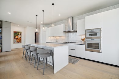 Chef's kitchen has Thermador appliances and Pedini