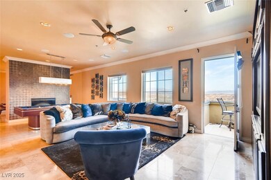 Living area featuring a ceiling fan, crown molding