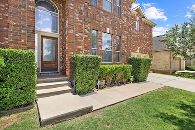View of exterior entry featuring brick siding and