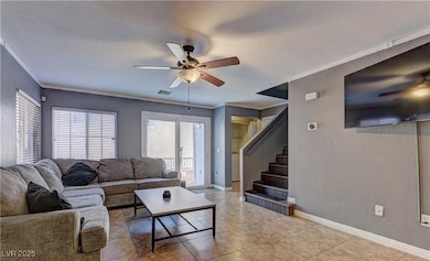Tiled living room with crown molding, a ceiling fa
