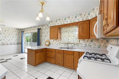 Kitchen with white appliances, light countertops, 