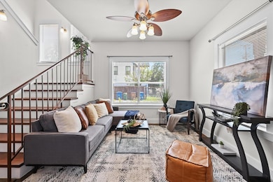 Living area with plenty of natural light, stairs,