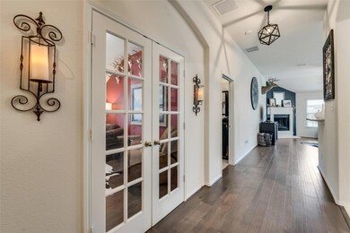 Corridor with french doors and dark hardwood / wood-style floors