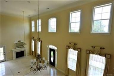 ELEGANT LIVING ROOM AREA IS CARPETED - TILE LEADS 