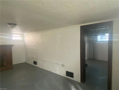 Basement featuring a textured ceiling
