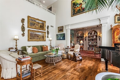 Sitting room featuring a high ceiling and wood finished floors