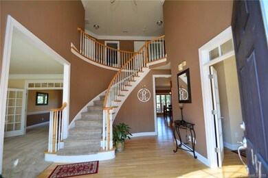 Entrance to foyer and grand spiral staircase