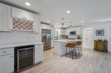 Featuring wine cooler, light hardwood-style porcel