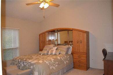 Master Bedroom with lighted ceiling fan.