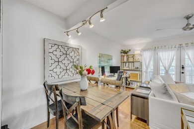 Dining area featuring ceiling fan, rail lighting,