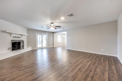 Unfurnished living room featuring dark wood-style 
