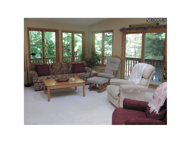 A view of the sun room with windows on all sides a