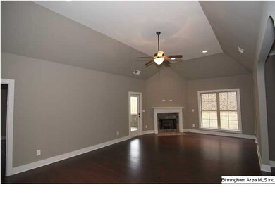 Living Room with a vaulted ceiling and gas log fir