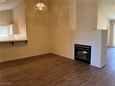 Unfurnished living room featuring dark wood-type f