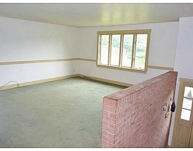Living Room. A Spacious Living Room with Carpeting