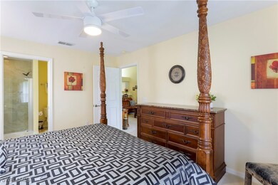 Bedroom featuring ensuite bathroom and ceiling fan