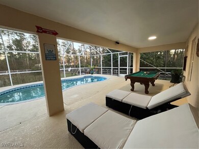 View of pool with a patio and enclosure