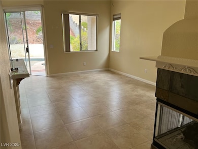 Unfurnished living room with baseboards and light tile patterned floors