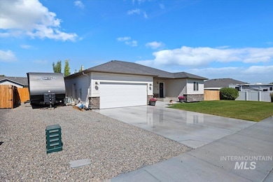 Single story home with a garage, stone siding, and concrete driveway