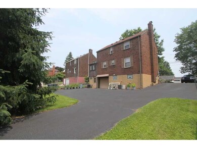 Exterior Back. Paved Drive leads to Garage at the 