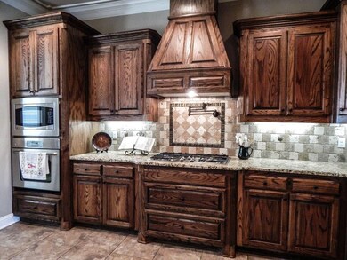 Granite counters, ceramic tile backsplash, gas coo