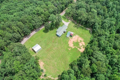 Aerial overview of property's location featuring a forest