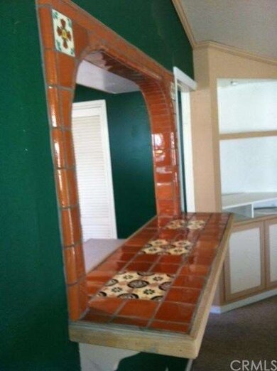 Spanish tile and arch way line the small bar leadi